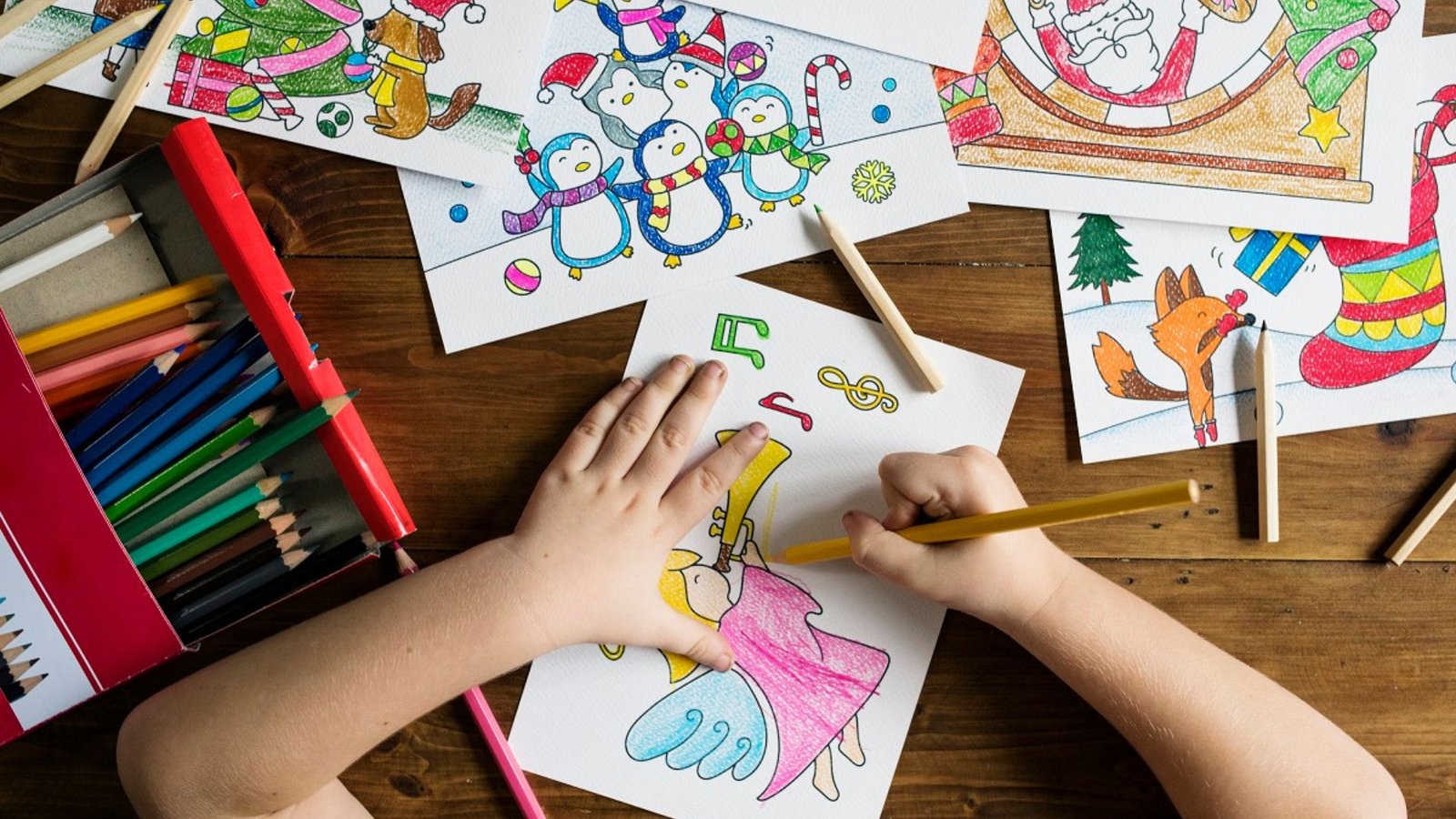 a child drawing using colours showing literacy arts 
